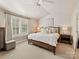 Serene main bedroom with neutral tones, natural light, and a comfortable king-size bed at 4407 Coventry Row Ct, Charlotte, NC 28270