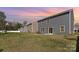 Exterior view of the home showcasing a spacious backyard with lush grass and privacy fencing at 4538 Opus Ln, Charlotte, NC 28214