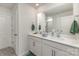 Bright bathroom with double sink vanity, a large mirror, white cabinets, and a shower with glass doors at 4538 Opus Ln, Charlotte, NC 28214