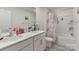 Bright bathroom boasts double sinks, a large mirror, and a combined shower and tub with curtain at 4538 Opus Ln, Charlotte, NC 28214