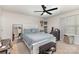 Nicely decorated bedroom features a comfortable bed, large mirror, ceiling fan, and a shelf for shoes at 4538 Opus Ln, Charlotte, NC 28214
