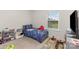 Bright bedroom with a twin bed, playful bedding, and a view to the exterior through the window at 4538 Opus Ln, Charlotte, NC 28214