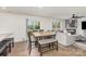 Open-concept dining area featuring a wooden table, seating for six, and access to the backyard at 4538 Opus Ln, Charlotte, NC 28214