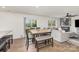 Open-concept dining area featuring a wooden table, seating for six, and access to the backyard at 4538 Opus Ln, Charlotte, NC 28214