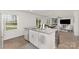 Open concept kitchen with granite countertops, stainless sink, white cabinetry, and adjacent living and dining areas at 4538 Opus Ln, Charlotte, NC 28214