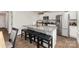 Modern kitchen with granite countertops, stainless steel appliances, and a breakfast bar with seating at 4538 Opus Ln, Charlotte, NC 28214