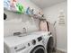 Modern laundry room with front load washer and dryer, overhead shelving for storage, and hanging area at 4538 Opus Ln, Charlotte, NC 28214