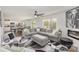 Open-concept living area showcasing a gray sectional, a view of the kitchen, and sliding glass doors at 4538 Opus Ln, Charlotte, NC 28214