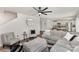 Open-concept living area showcasing a gray sectional, a view of the kitchen, and a staircase at 4538 Opus Ln, Charlotte, NC 28214