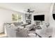 Spacious living room featuring a comfortable gray sectional, a fireplace, and a ceiling fan at 4538 Opus Ln, Charlotte, NC 28214