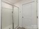 Modern walk-in shower features glass doors, sleek fixtures and tiled walls with built-in shelves for toiletries at 4538 Opus Ln, Charlotte, NC 28214