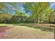 Expansive backyard showing the lush grass and a few trees around the edge of the property at 4937 Broken Saddle Ln, Charlotte, NC 28226