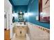 Elegant powder room with a marble-top vanity, designer mirror, and decorative sconces, adding a touch of sophistication at 4937 Broken Saddle Ln, Charlotte, NC 28226