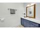 A light and bright bathroom features a sink vanity, decorative mirror, and tiled floor at 4937 Broken Saddle Ln, Charlotte, NC 28226