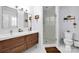 Modern bathroom with double sinks, a walk-in shower, and ample natural light at 4937 Broken Saddle Ln, Charlotte, NC 28226