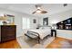 This is a bedroom with a ceiling fan, hardwood floors, and a sitting bench at 4937 Broken Saddle Ln, Charlotte, NC 28226