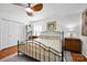 Bright bedroom showcasing hardwood floors, ceiling fan, and a view of the closet space for ample storage at 4937 Broken Saddle Ln, Charlotte, NC 28226