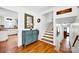 Bright foyer with hardwood floors, a staircase, and stylish decor, with a peek into the kitchen at 4937 Broken Saddle Ln, Charlotte, NC 28226