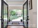 Inviting foyer featuring a glimpse of the outdoors through the glass front doors and the beautiful landscaping at 4937 Broken Saddle Ln, Charlotte, NC 28226