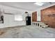 Spacious garage with ample storage, a refrigerator, and a convenient utility sink at 4937 Broken Saddle Ln, Charlotte, NC 28226