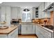 Bright kitchen featuring stainless steel appliances, white cabinets, granite countertops, and wood flooring at 4937 Broken Saddle Ln, Charlotte, NC 28226