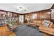 Inviting living room with wood paneling, hardwood floors, and bookshelf, creating a warm and welcoming atmosphere at 4937 Broken Saddle Ln, Charlotte, NC 28226