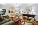 Elegant living room with hardwood floors, a vintage cabinet, and a view to the dining area at 4937 Broken Saddle Ln, Charlotte, NC 28226
