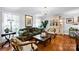 Bright living room with a chandelier, stylish furnishings, hardwood floors, and white trim at 4937 Broken Saddle Ln, Charlotte, NC 28226