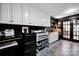 Bright office boasts built-in cabinetry, a functional workspace, and glass paneled doors at 4937 Broken Saddle Ln, Charlotte, NC 28226