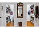 View of walk-in closets featuring custom shelving and organization spaces in a home with hardwood floors at 4937 Broken Saddle Ln, Charlotte, NC 28226