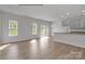 Bright living room with hardwood floors adjacent to kitchen and view of back yard at 5345 Cherrie Kate Ct # 1804, Stanley, NC 28164