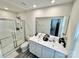 Bathroom featuring a double vanity, glass shower, and modern fixtures at 5861 Camp Sw Ct, Concord, NC 28025