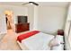 This bright bedroom has a ceiling fan, a closet, and a charming white and red quilt on the bed at 5861 Camp Sw Ct, Concord, NC 28025