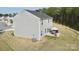 This home boasts gray siding, a patio with a table and umbrella, and a well-manicured lawn at 5861 Camp Sw Ct, Concord, NC 28025