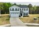 Beautiful home with gray siding, a two-car garage, and a spacious driveway in a landscaped yard at 5861 Camp Sw Ct, Concord, NC 28025