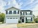 Beautiful home with gray siding, a two-car garage, and a spacious driveway in a landscaped yard at 5861 Camp Sw Ct, Concord, NC 28025