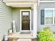 Inviting front porch with stylish decor, a modern door, and well-maintained landscaping at 5861 Camp Sw Ct, Concord, NC 28025