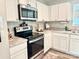 This kitchen features white cabinets, stainless steel appliances, and stylish countertops at 5861 Camp Sw Ct, Concord, NC 28025