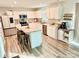 Modern kitchen with white cabinetry, stainless steel appliances, a large island, and sleek countertops at 5861 Camp Sw Ct, Concord, NC 28025