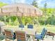 The backyard patio features a table with seating for six, an umbrella, and plenty of room to relax at 5861 Camp Sw Ct, Concord, NC 28025