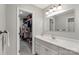 Bathroom vanity and mirror with a view into a walk-in closet at 6605 Point Comfort Ln, Charlotte, NC 28226