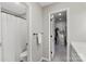 Bathroom and walk-in closet featuring a toilet, shower and clothing racks at 6605 Point Comfort Ln, Charlotte, NC 28226