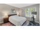 Cozy bedroom with queen bed, side tables, lamps, circular mirror, and exercise bike at 6605 Point Comfort Ln, Charlotte, NC 28226