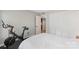 Bright bedroom featuring a Peloton exercise bike, large closet, and an open doorway at 6605 Point Comfort Ln, Charlotte, NC 28226