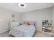 Cozy bedroom featuring a bed with a rainbow-themed blanket, bookcase, and a white dresser at 6605 Point Comfort Ln, Charlotte, NC 28226