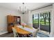 Dining room with a modern chandelier and sliding door access to the outside at 6605 Point Comfort Ln, Charlotte, NC 28226