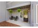 Inviting condo entrance with a seating area and hanging plants at 6605 Point Comfort Ln, Charlotte, NC 28226