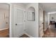 Clean hallway with wood-look floors, closet, and neutral walls at 6605 Point Comfort Ln, Charlotte, NC 28226