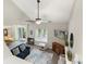 Open living room featuring vaulted ceilings, a fan, and connected dining room at 6605 Point Comfort Ln, Charlotte, NC 28226