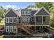Spacious home's rear exterior boasts a large deck and patio, perfect for outdoor living at 6743 Fox Ridge Cir, Davidson, NC 28036